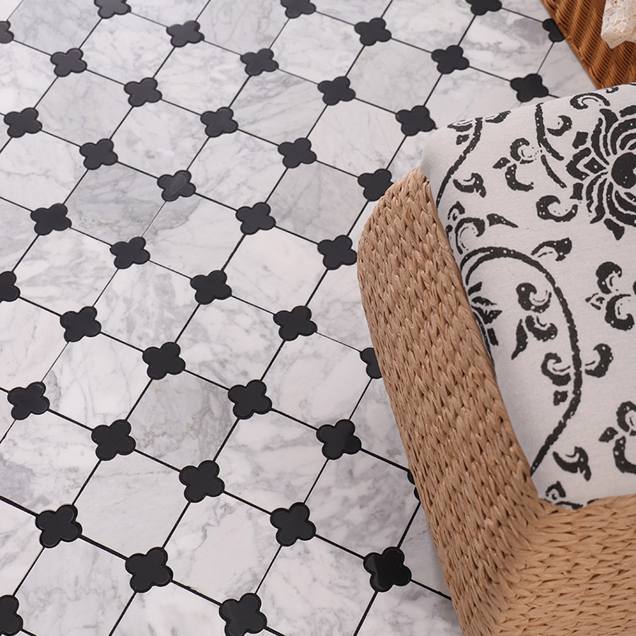 Marble floor with black quatrefoil pattern and wicker chair corner