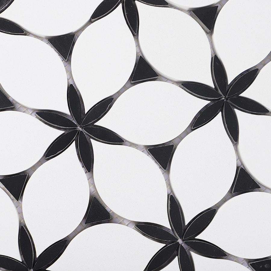 Detailed view of geometric petal pattern in black and white marble tile.