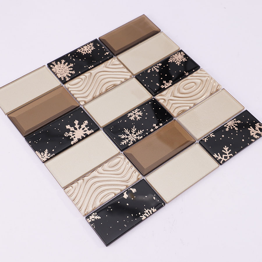 Angled view of black and brown crystal glass tile with snowflake and beige tones.