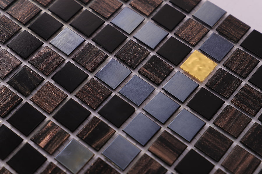 Glossy black and brown square mosaic with one gold foil tile