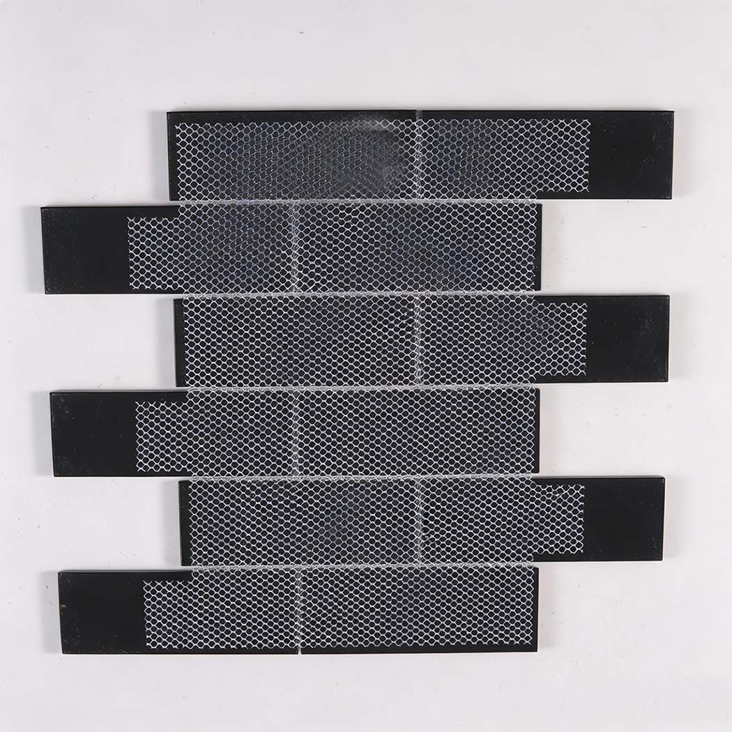 Back view of black glass subway tile sheet with white mesh mounting