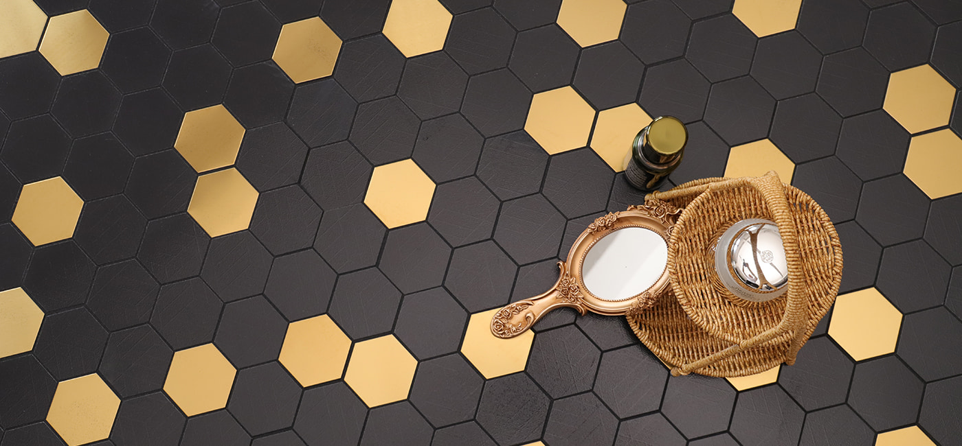 A stylish black and gold hexagonal tile pattern, perfect for adding sophistication to any room.