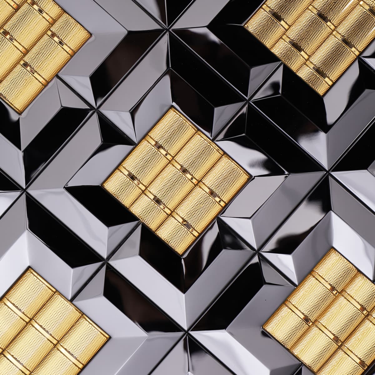 Close-up of glossy black and gold square stainless mosaic tile