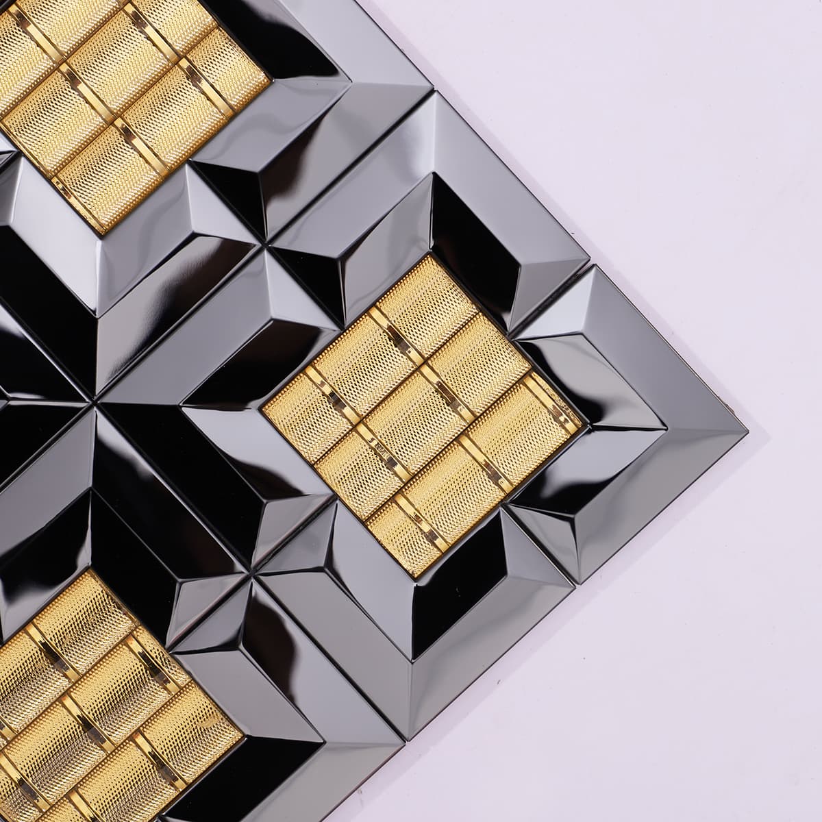 Corner detail of black and gold mosaic tile with raised square pattern