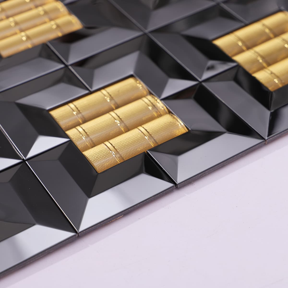 Side view of raised black and gold square mosaic tile surface