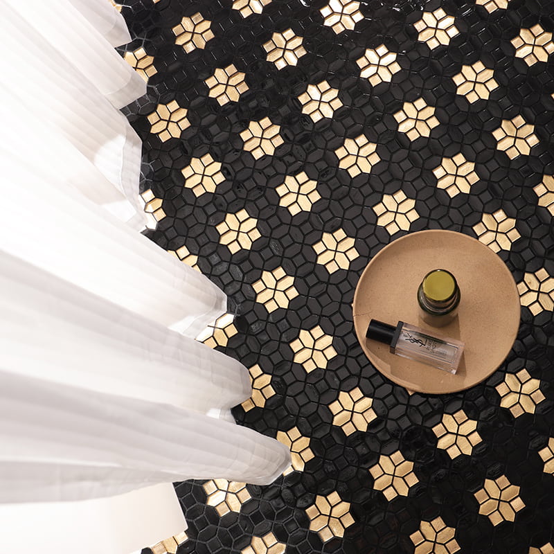 Black and gold star pattern glass mosaic tiles on floor