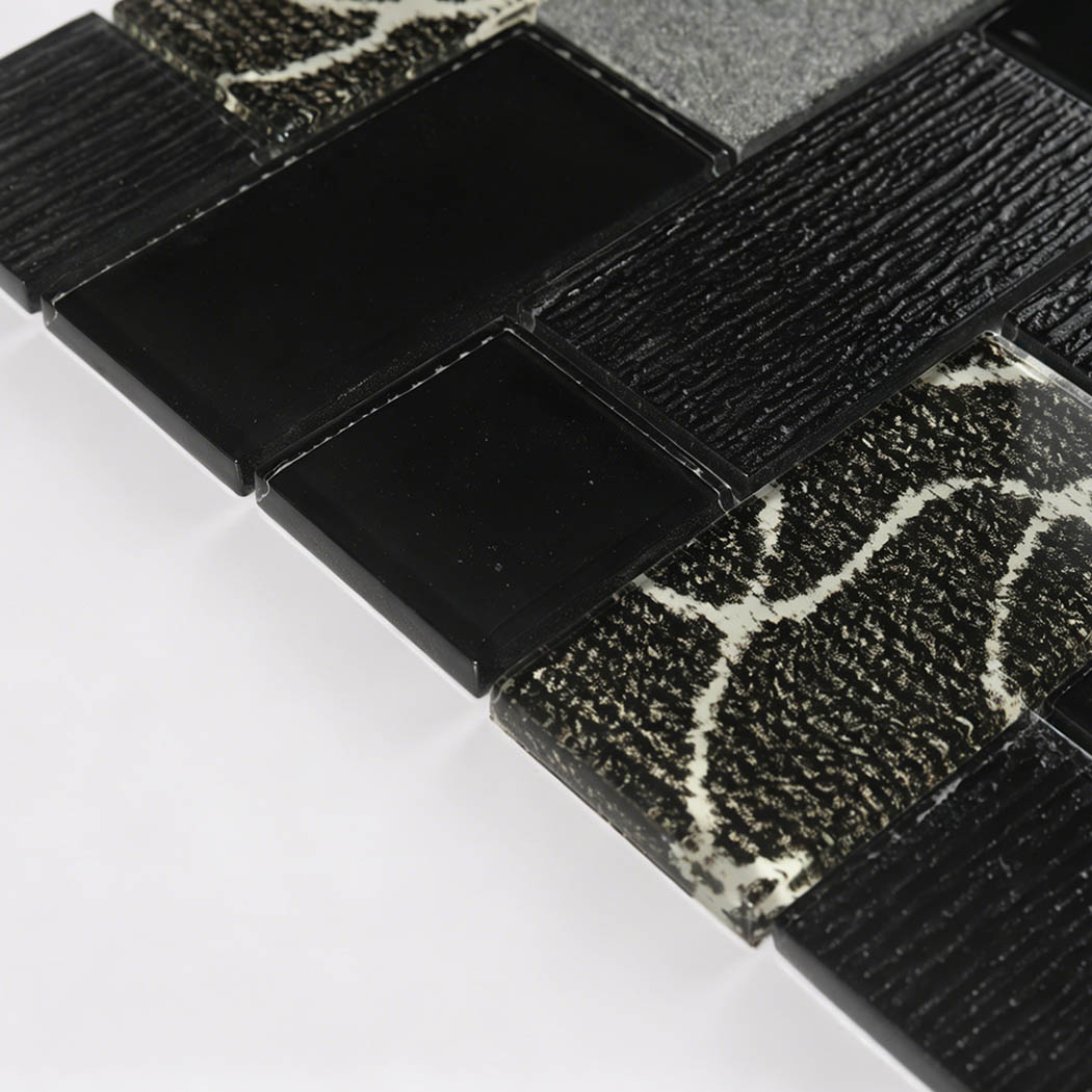 Side view of black gray glass brick mosaic showing tile thickness and mixed textures