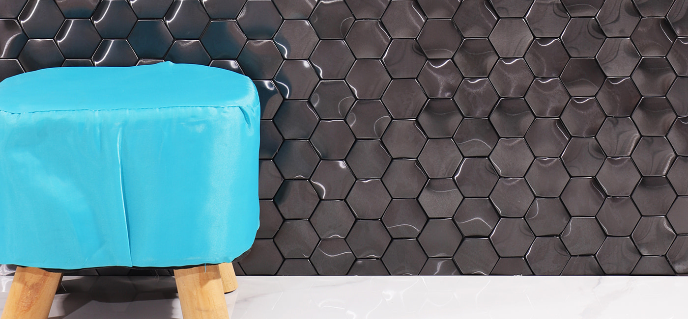 Glossy black hexagon tiles on a wall with a smooth, modern finish