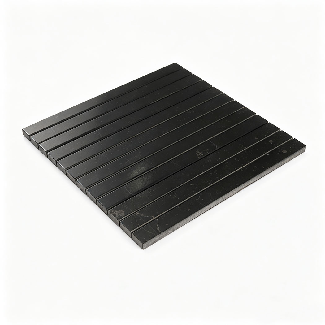 Angled view of a black linear marble mosaic sheet with long narrow strips