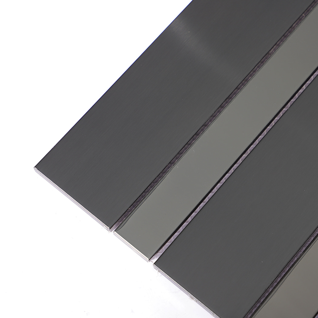 Close-up of brushed and polished black stainless steel linear wall tile surface