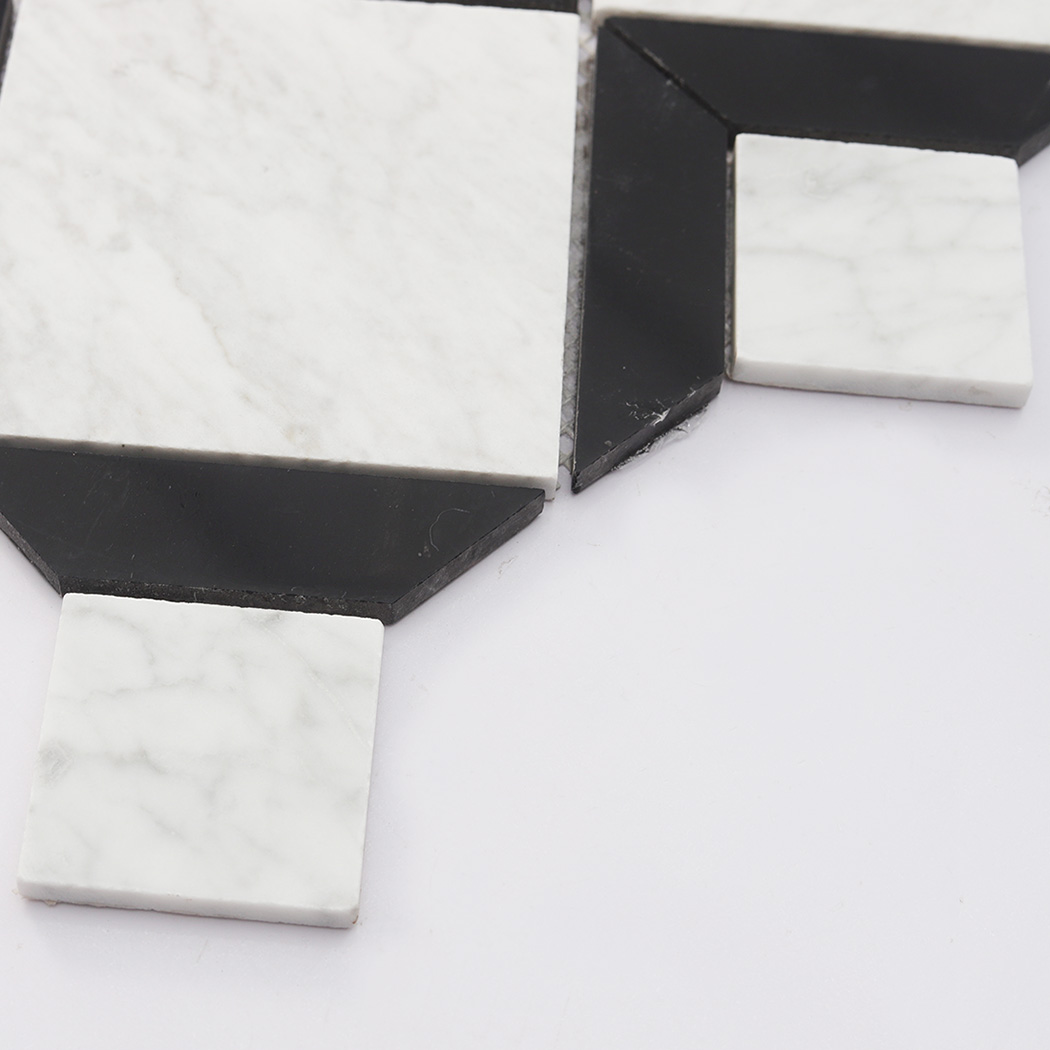 Black marble corner accent beside white square insert in geometric mosaic tile