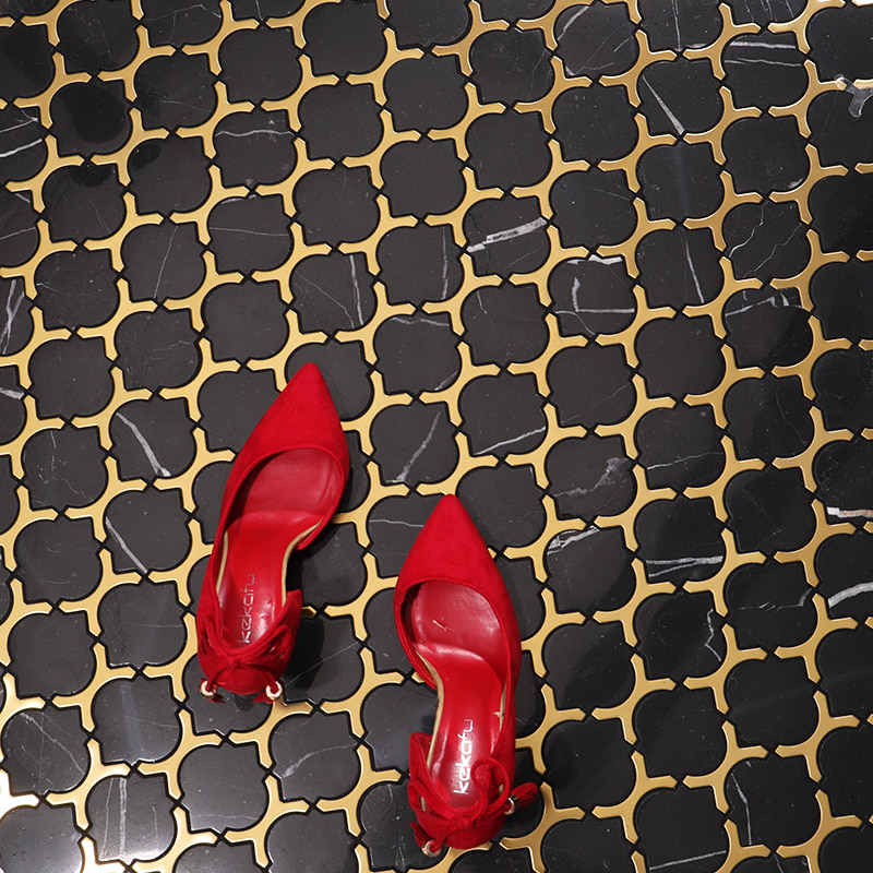 Black marble and gold stainless steel clover mosaic tile floor
