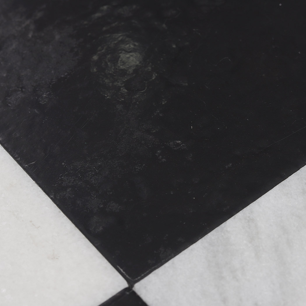 Close-up of the natural texture on a black marble mosaic center tile