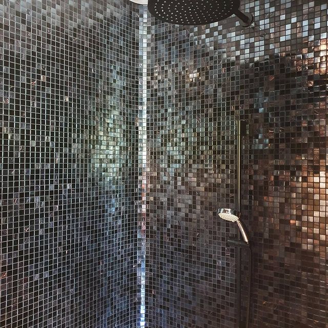 Black metallic-effect mosaic tiles in modern shower