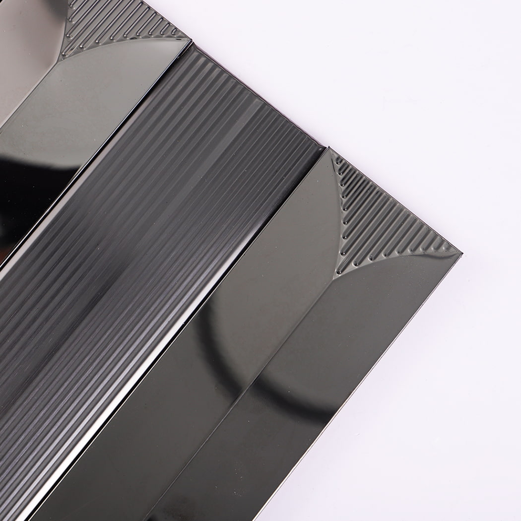 Corner close-up showing texture and shine of black metallic mosaic tile.