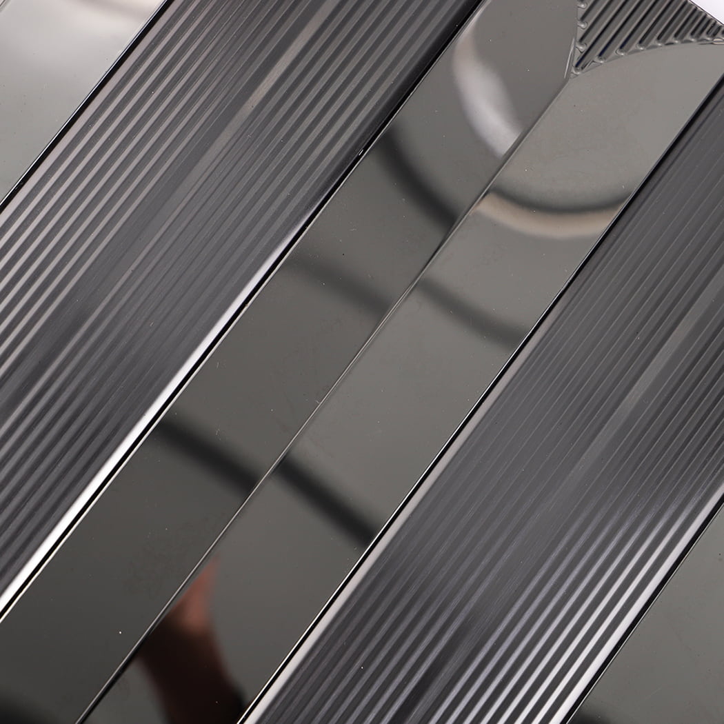 Surface detail showing vertical texture of black metallic mosaic tile.