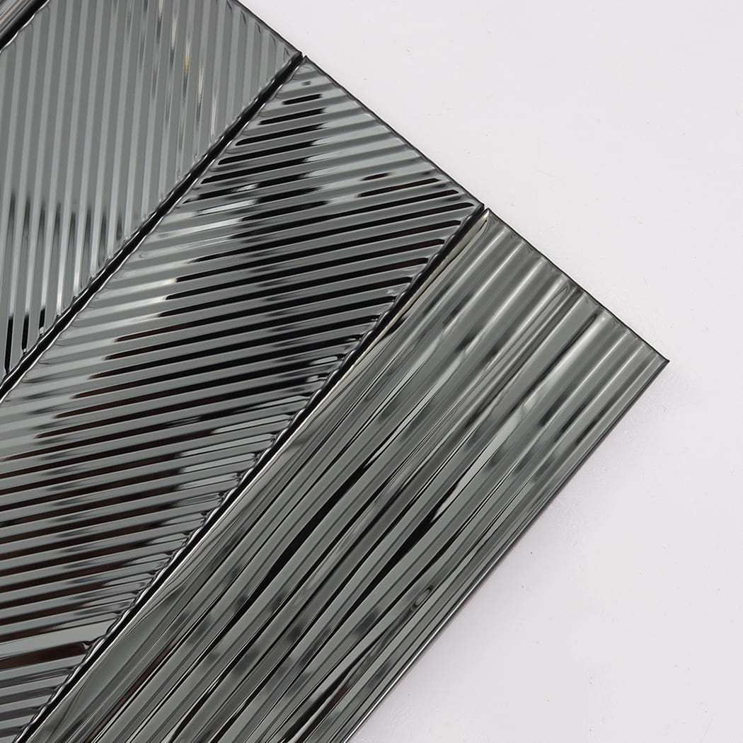 Corner close-up of black mirror stainless steel tile with reflective grooved texture