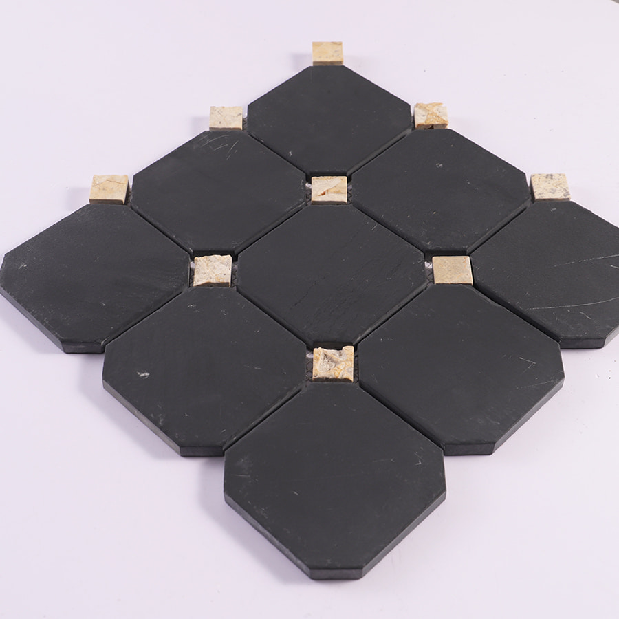 Angled view of black octagon marble mosaic with beige square accents