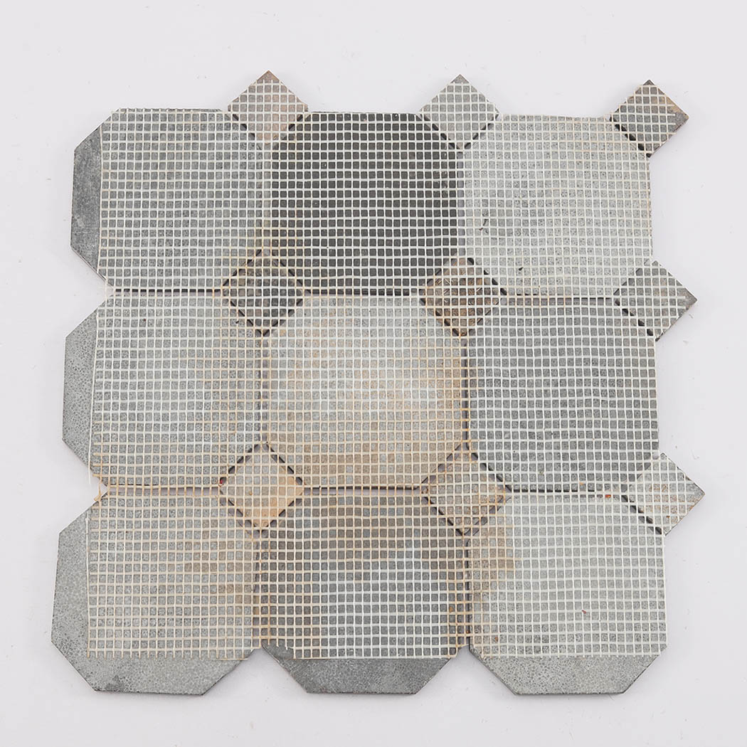 Back view of deep brown octagon mosaic tile showing mesh mounted backing