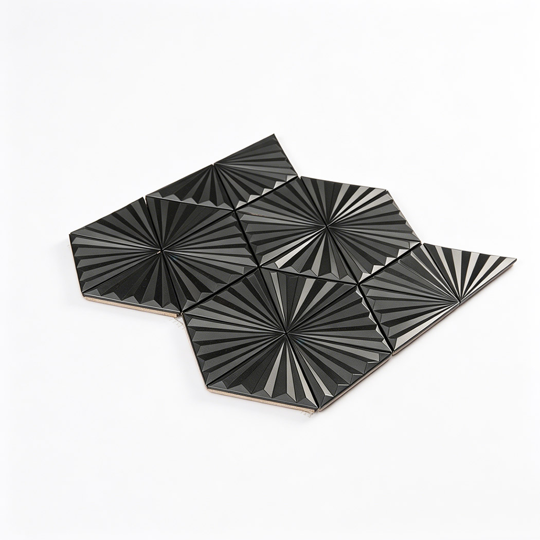 Angled view of black raised triangle metal mosaic tile sheet