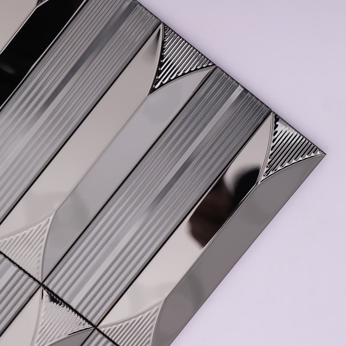  Close-up of glossy black stainless steel tile with vertical grooves