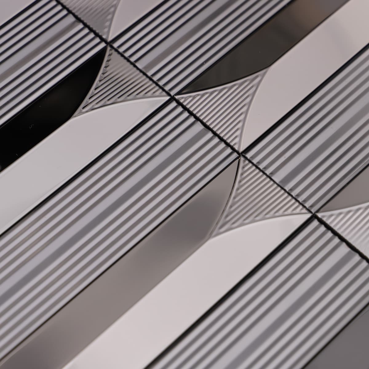 Detailed view of curved pattern on black stainless steel mosaic tiles