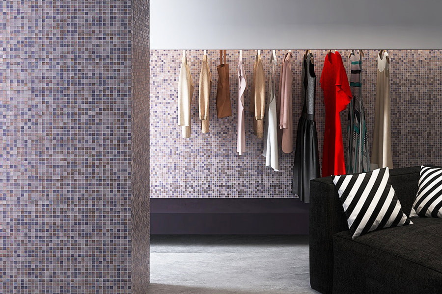 Black sofa with striped pillows against purple mosaic tile backdrop