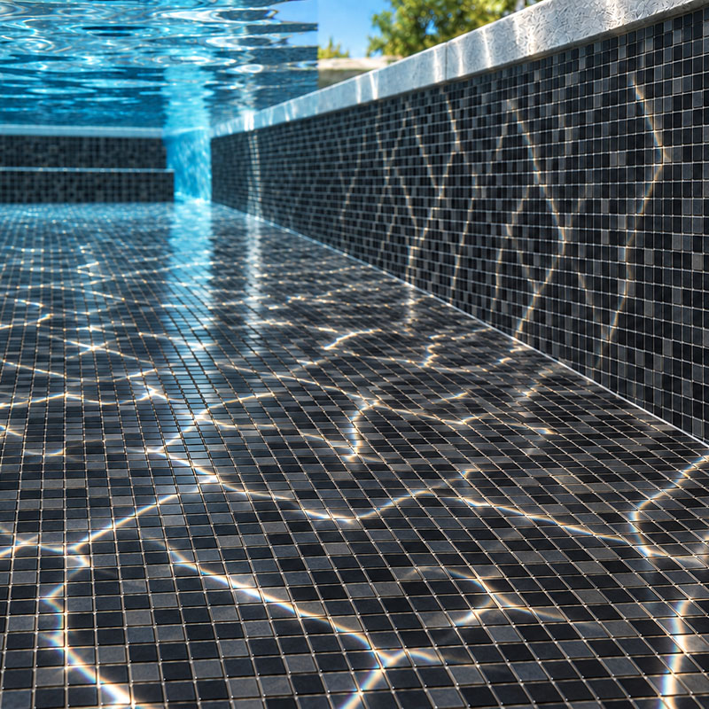 Black square mosaic pool tiles with bright water reflections