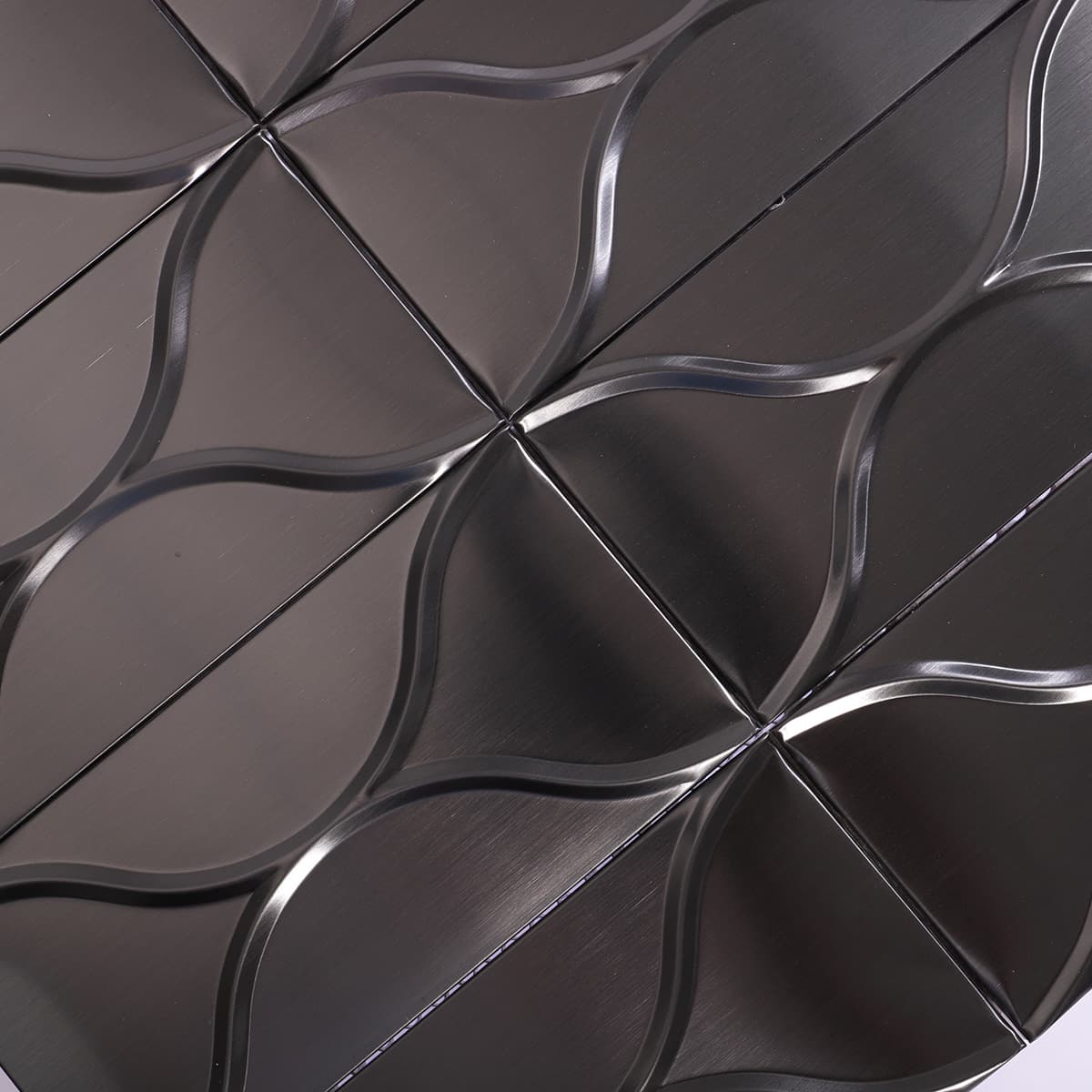 Curved pattern close-up on black stainless steel tiles