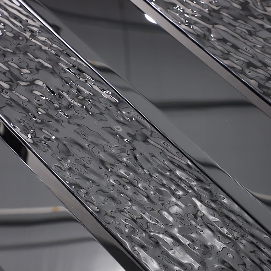 Close-up of textured black stainless steel vertical subway mosaic tile surface