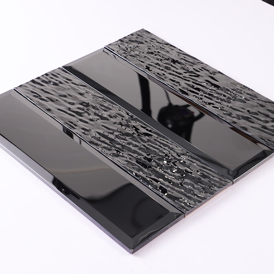 Angled view of black stainless steel vertical subway mosaic tile with reflective finish