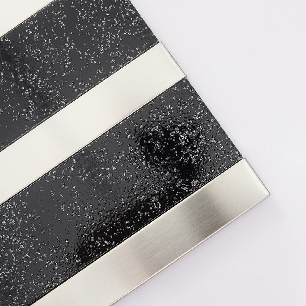 Glossy black electroplated stone close-up with smooth silver stainless steel trim