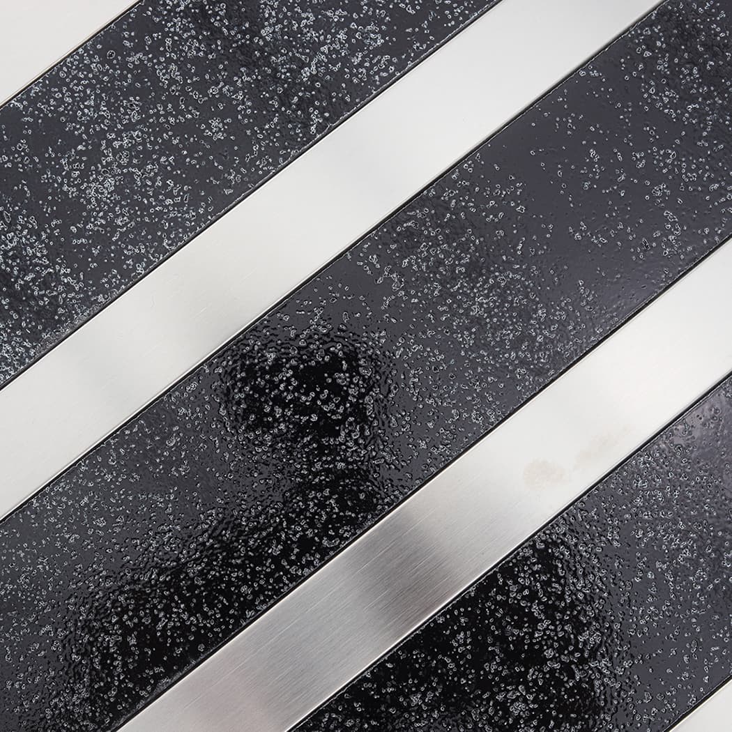 Black speckled electroplated stone texture with clean silver stainless steel lines