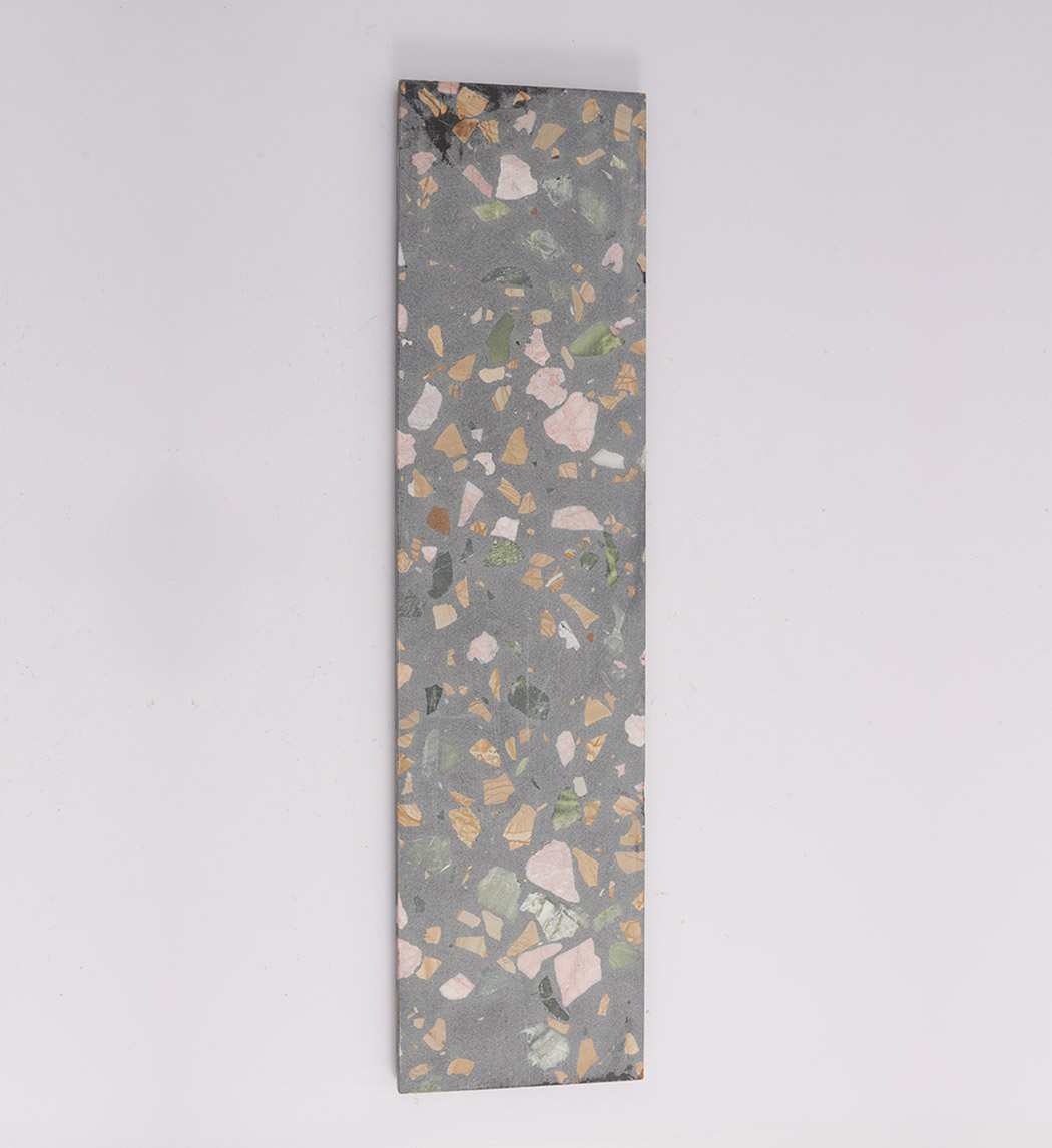 Back view of black terrazzo fluted tile with flat gray terrazzo surface