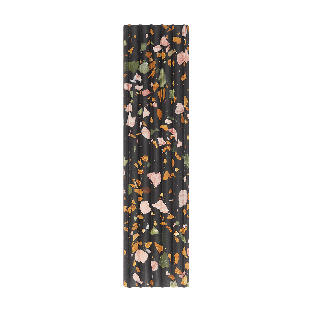 Front view of black terrazzo fluted tile with colorful stone chips