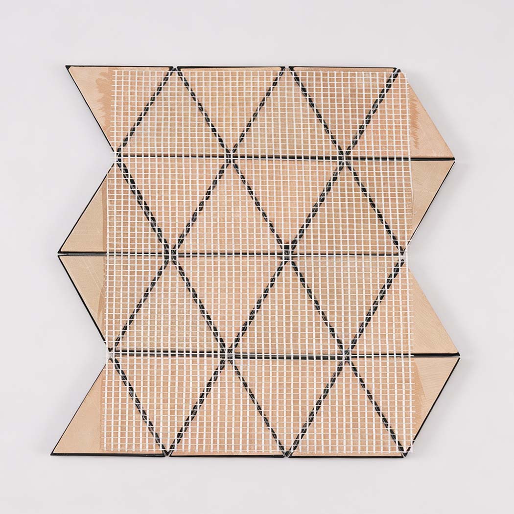 Back view of black triangle metal mosaic tile sheet with mesh mounting
