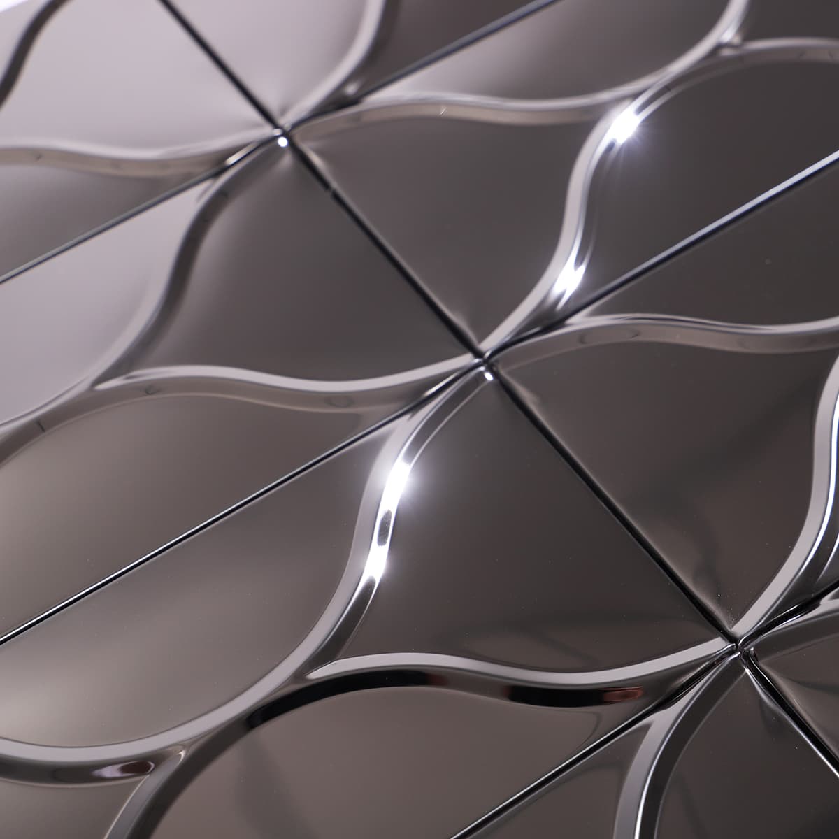 Shiny black stainless steel mosaic tile showing flowing wave texture