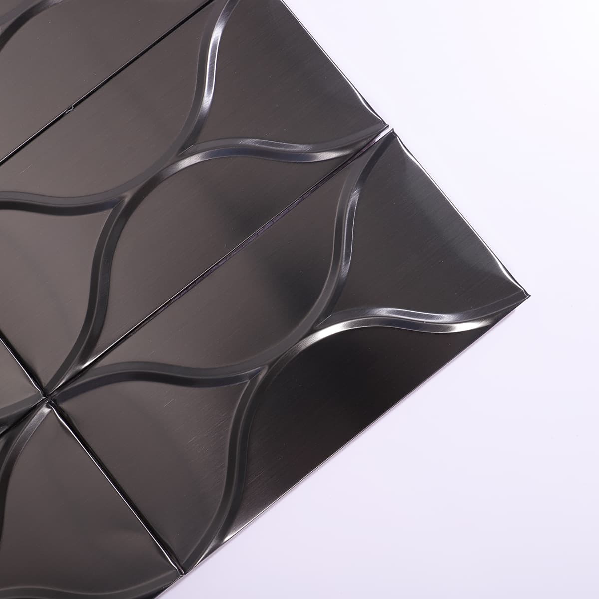 Corner detail of black brushed wave metal mosaic