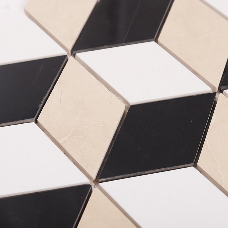 Close-up of black, white, and beige diamond marble floor tile