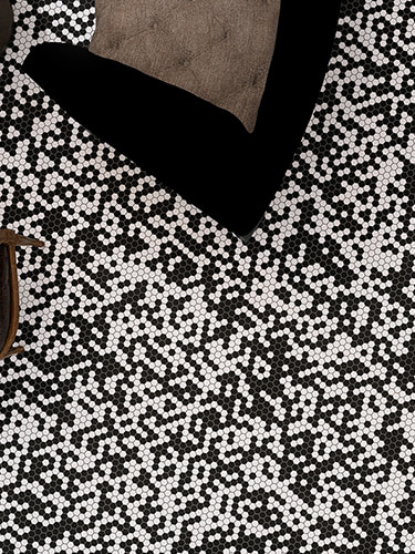 Vertical view of black and white hexagon mosaic tile floor with pixel-inspired design