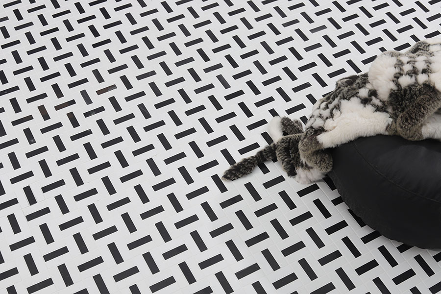 Black and white linear marble basketweave mosaic tile floor.