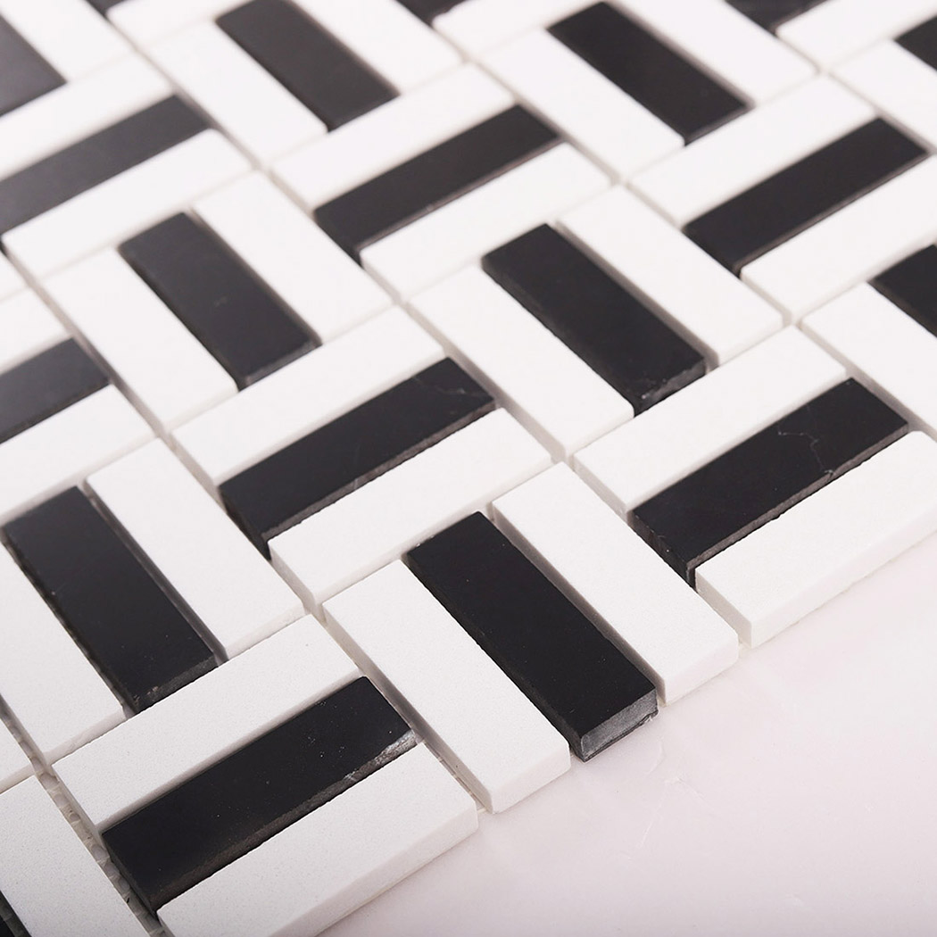Angled close-up of black and white mosaic tile surface detail