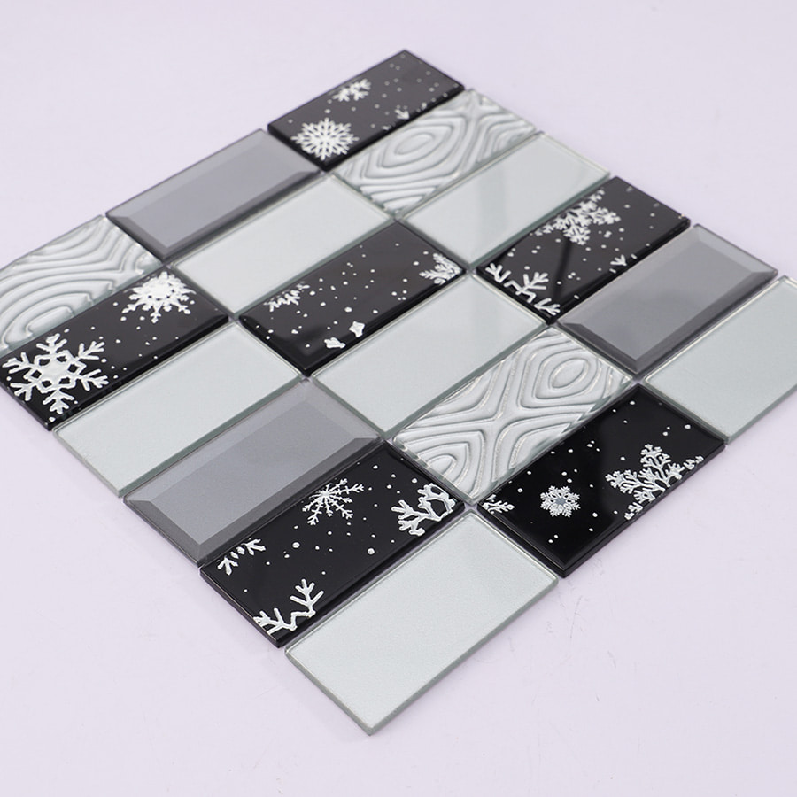 Angled view of black and white snowflake glass mosaic tile showing texture contrast