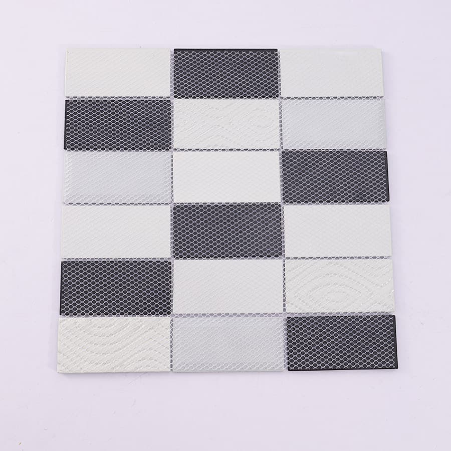 Back view of black and white snowflake rectangular glass mosaic tile with mesh backing