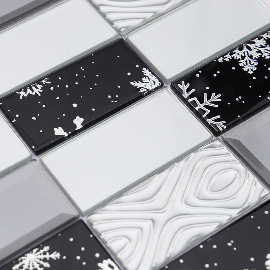 Surface detail showing embossed and glossy snowflake patterns on glass mosaic tile
