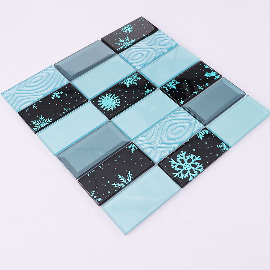 Angled view of blue and black crystal glass wall tile with elegant snowflake prints.