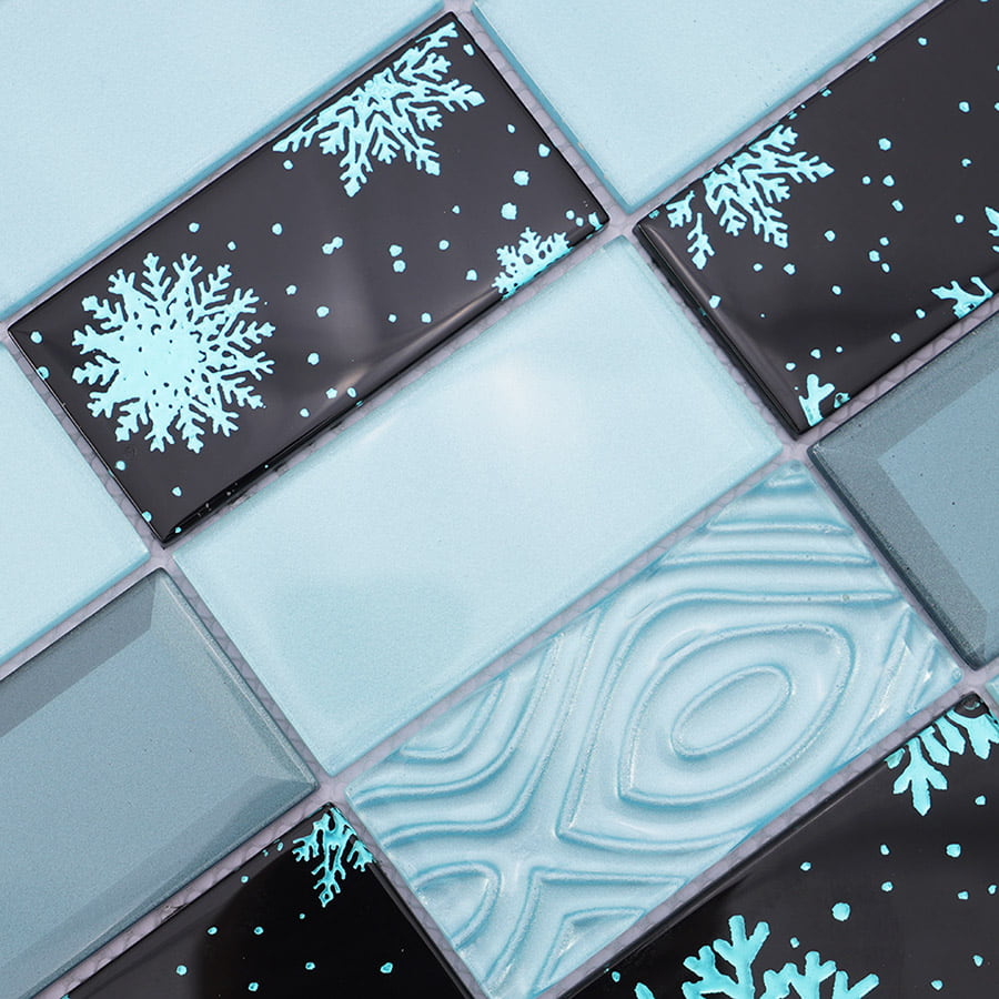 Close-up of blue and black crystal glass mosaic tile with textured snowflake pattern.