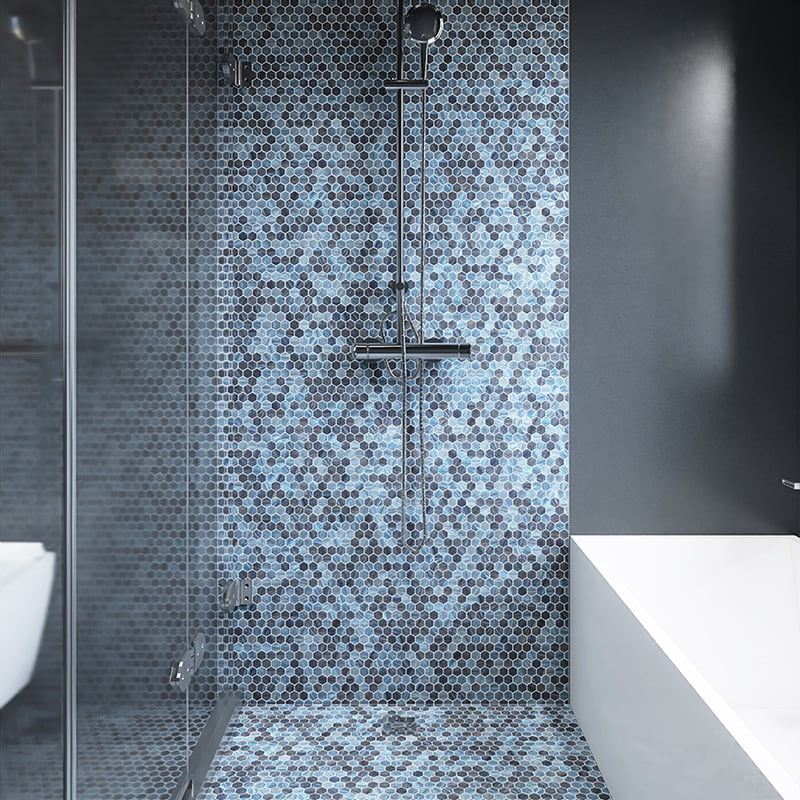 Modern shower wall covered in blue and black glass hexagon mosaic tiles