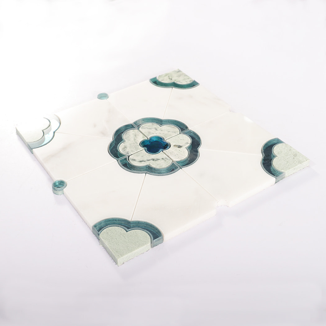 Angled view of assembled mosaic tile sheet with blue floral center and corners