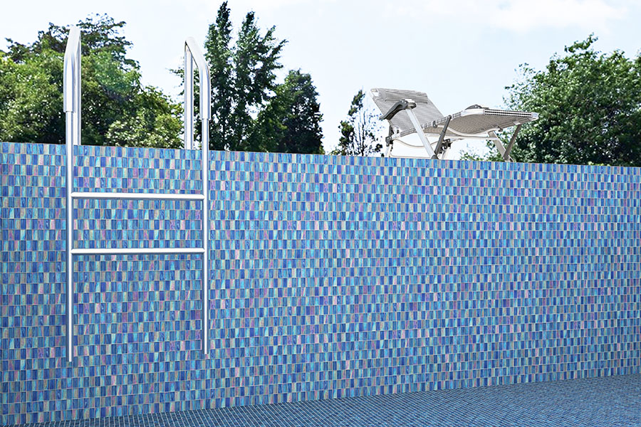 Blue iridescent glass mosaic pool wall and floor with patio umbrella